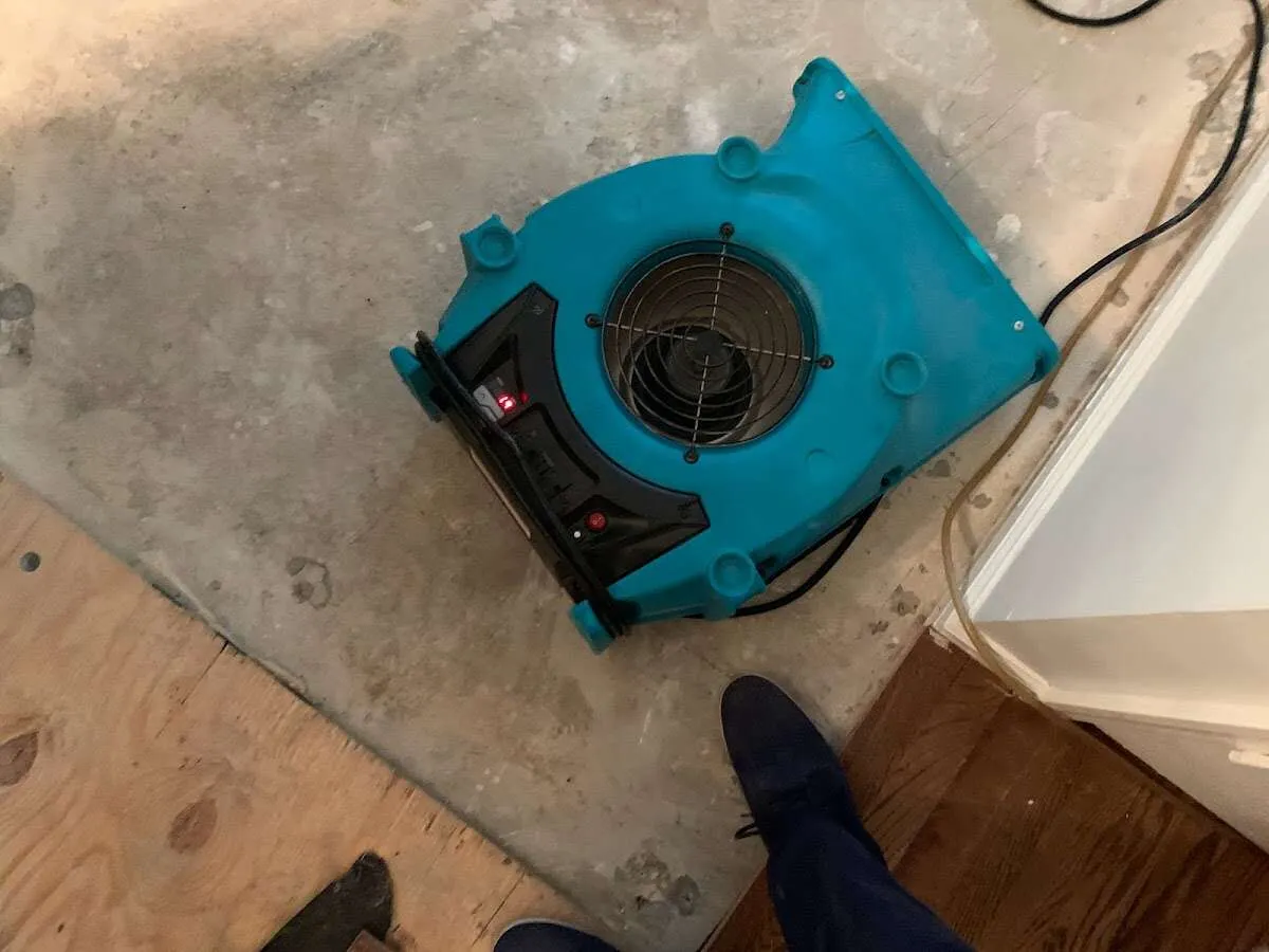 Air mover drying subfloor during Commercial Water Damage Restoration in Perkiomen